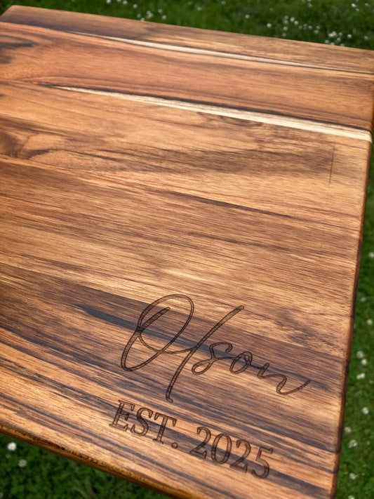 Cutting board engraved with a family name in script for a wedding gift