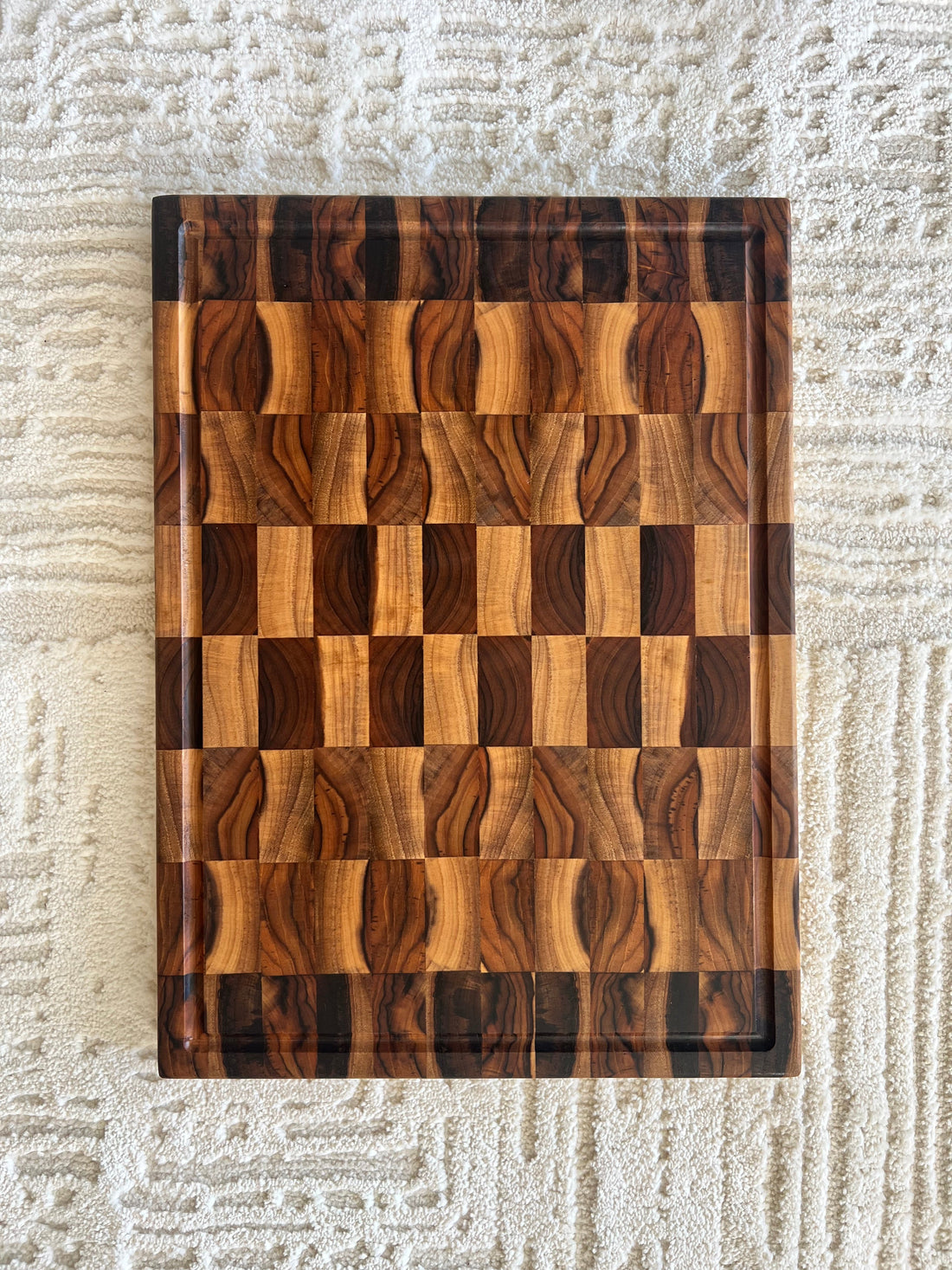 End grain teak cutting board showing checkerboard grain