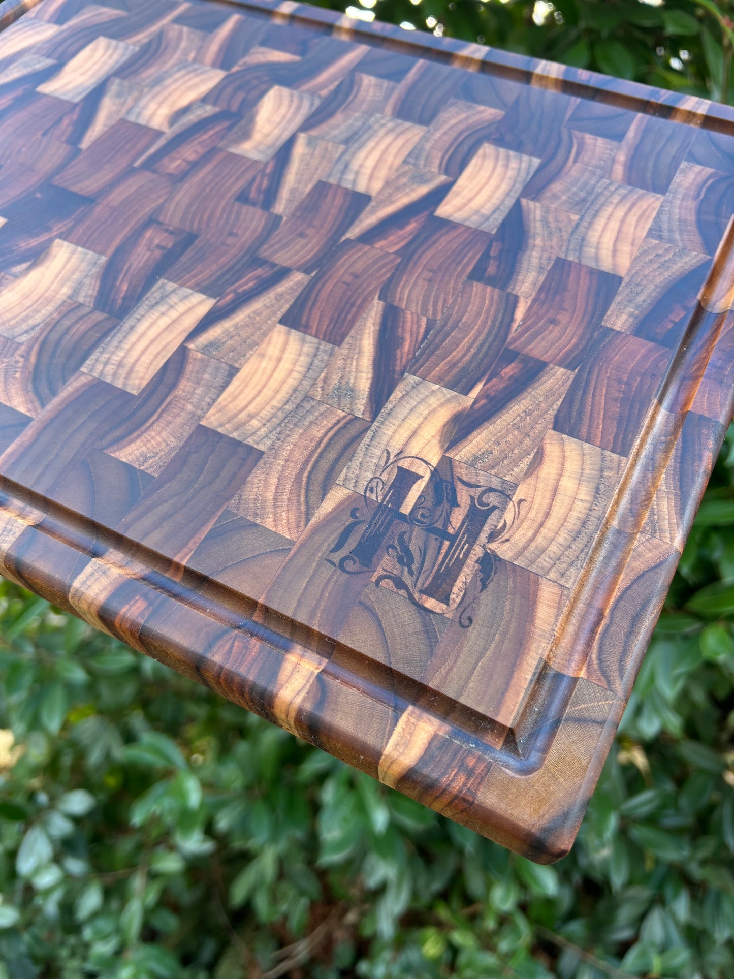 Teak end grain butcher block engraved with a custom monogram