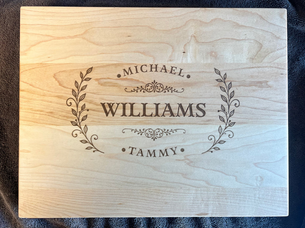 Hard maple cutting board with the Homestead laurel crest engraved across the full face with the names Michael, Williams and Tammy