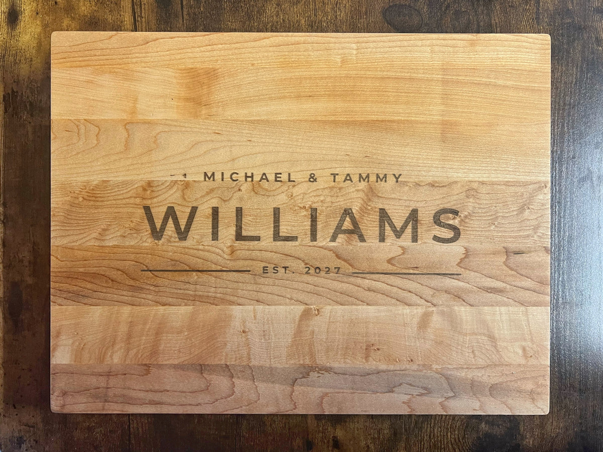 Hard maple cutting board with the Modern design engraved across the full face reading Michael and Tammy, Williams, Est. 2027