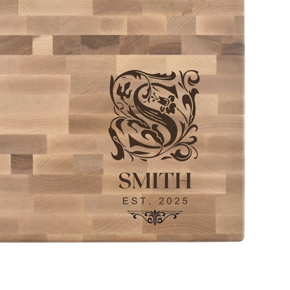 Hard maple end grain butcher block engraved with an ornate monogram initial, family name, and EST. date
