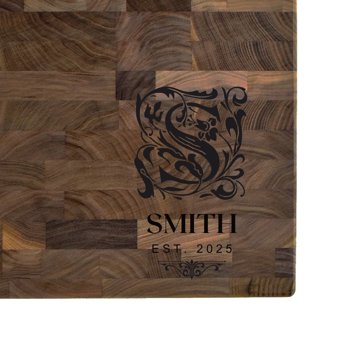 Black walnut end grain butcher block engraved with an ornate monogram initial, family name, and EST. date