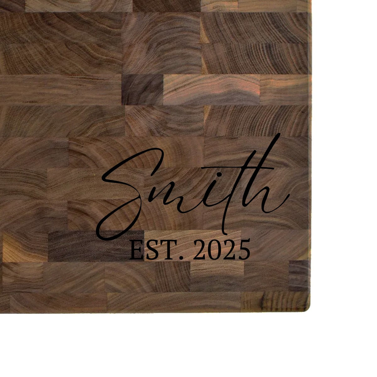 Black walnut end grain butcher block engraved with a family name in script and an EST. date