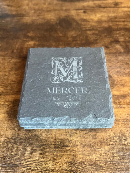 Close view of a slate coaster edge showing the naturally irregular broken stone edge and engraving depth