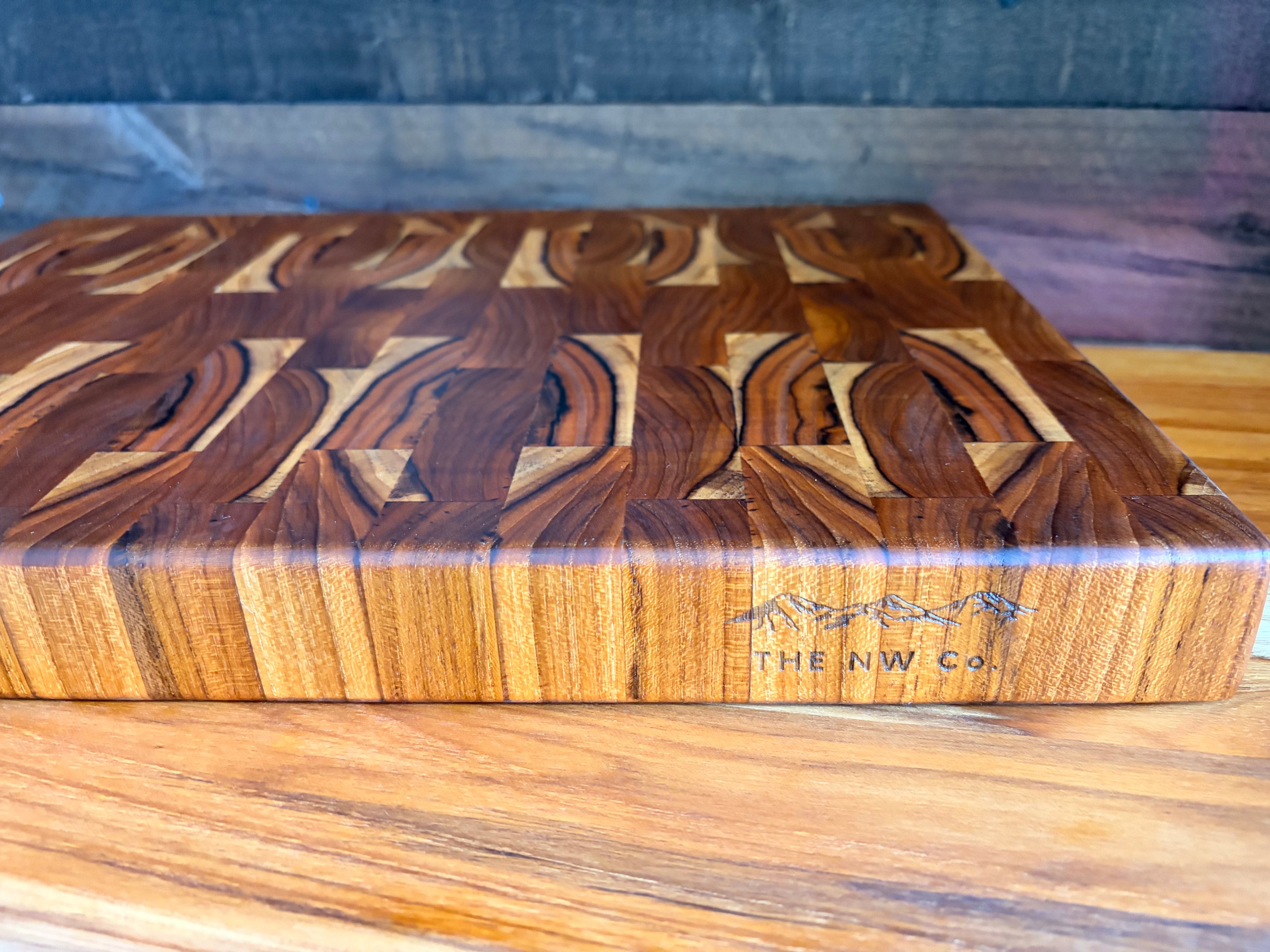Teak end grain butcher block, angled view showing thickness and branded maker's mark