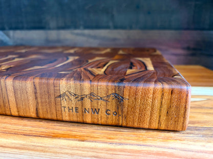 Teak end grain butcher block on a kitchen counter with branded maker's mark