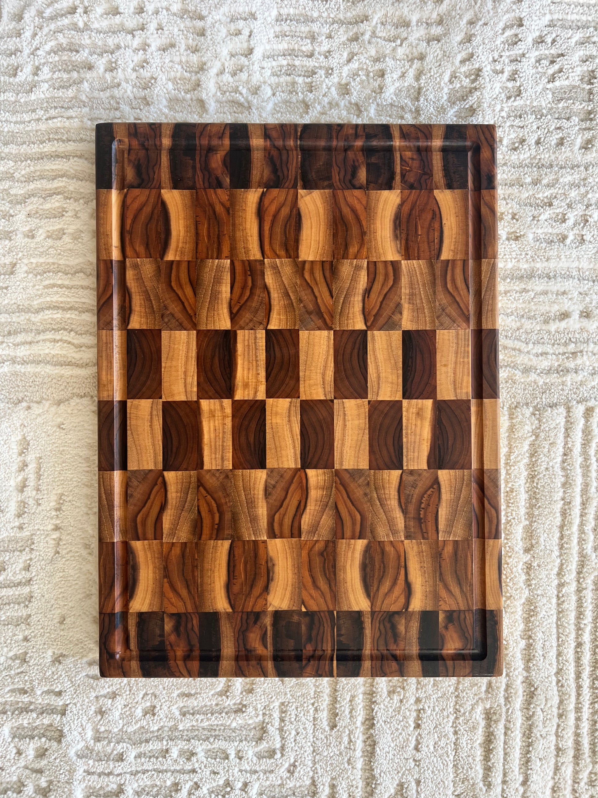 Teak end grain cutting board showing checkerboard grain pattern
